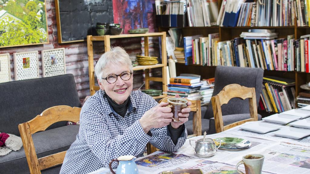 Bronwyn Theobald in her shed studio, with coffee m