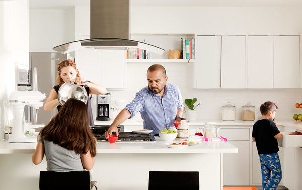 In the kitchen, the existing cabinets were updated with a coat of paint and topped with new Caesarstone countertops. The refrigerator, dishwasher, and mixer are from KitchenAid and the cooktop is GE.