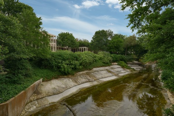 The view from the bridge over Bachman Creek, with the home's pool house on the opposite bank.