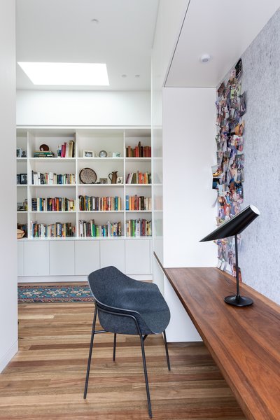 The original cottage has been reimagined to incorporate a study area. A built-in wood desk, felt tack board, and contemporary Ligne Roset desk chair provide an ideal work area.