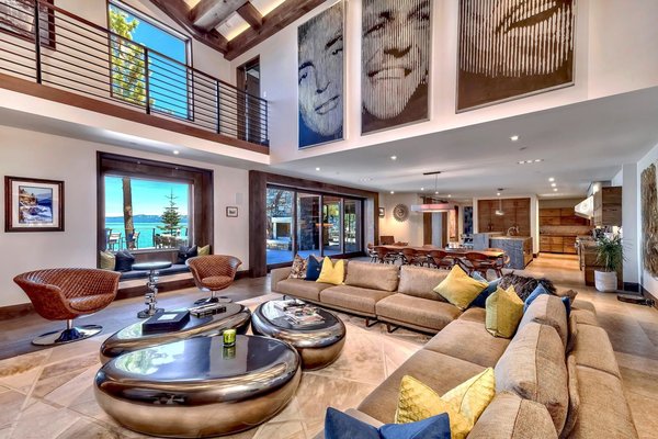 Images of Dean Martin, Frank Sinatra, and Sammy Davis Jr. adorn the double-height great room. 