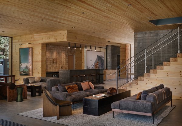The clubhouse's palette of cool concrete, pine, and steel makes rustic refined. The assortment of seating in the clubhouse's main area allows guests to occupy every space, but it still feels intimate with one or two people.
