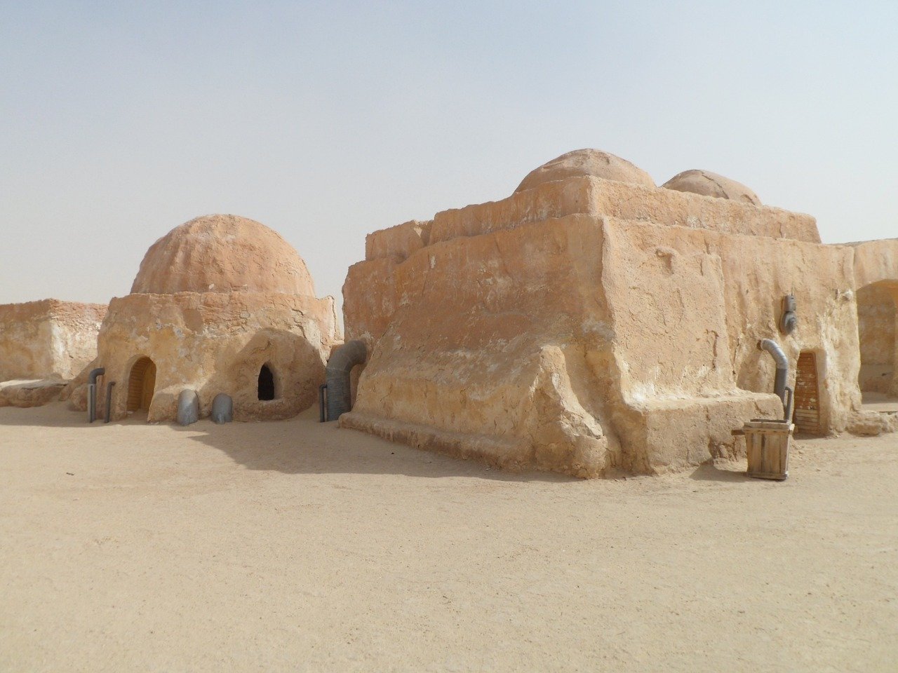 These Tunisian Berber dwellings are low-set and cave like, providing cool interiors that protect from the hot desert climate.