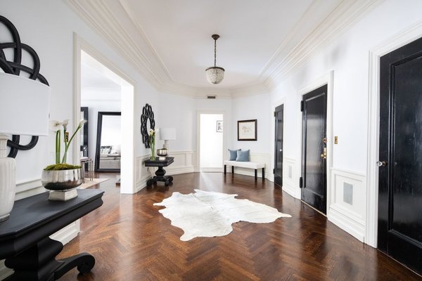 Sited at the corner of Park Avenue and 77th Street, the 3,025-square-foot apartment features an elongated, octagonal foyer with 10-foot-high ceilings and lustrous, herringbone-pattern original hardwood floors.