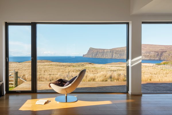 The living room of Wood H by Dualchas Architects has a sweeping view of the surrounding landscape and the Atlantic Ocean.