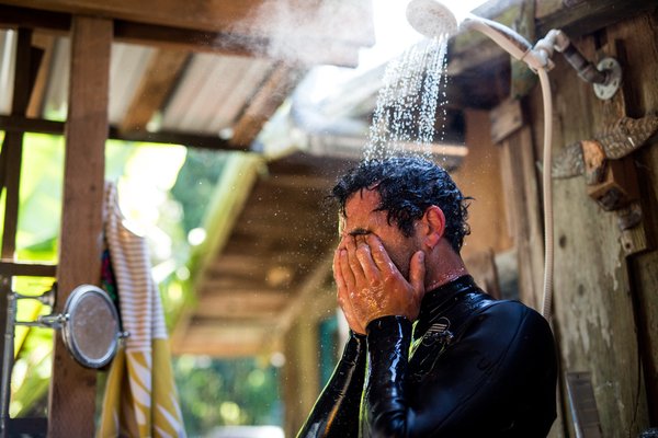 Taylor Stitch creative director Mikey Armenta rinses off at this Bolinas, California, surf retreat.