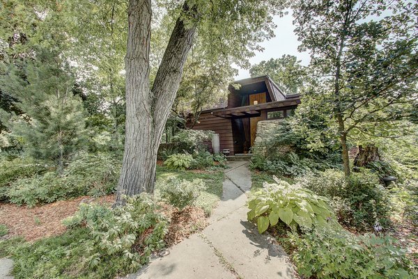 The home's shady corner lot is full of large Maple trees and lush plantings. A deep eave marks the grand entrance, which is further dramatized by 15-foot-tall double doors with Medieval-style hardware from Spain.