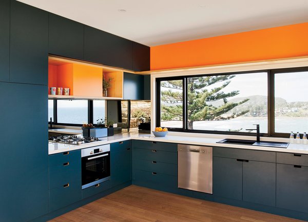 Inspired by the sea and sand, Richard and Jackie Willcocks chose blue and orange joinery colors for their 1,140-square-foot prefab. The modular home is by New South Wales company ArchiBlox.