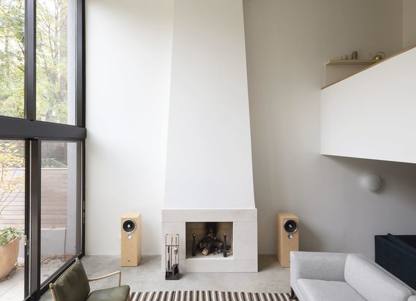 The fireplace, flanked by speakers, is a central feature of the living room.