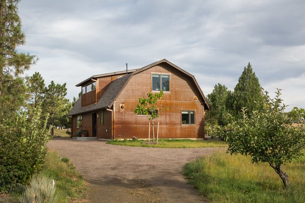 The exterior of the Modern Barn by HMHAI retains the classic barn appearance, with the addition of carefully placed windows and industrial-looking Corten steel siding.