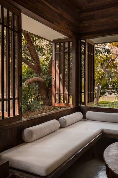 Nestled in a mango grove, Studio Mumbai’s Chondi residence bridges two opposing desires: a wish to bring nature indoors and, yet, to be sheltered from it. Its thin wooden walls welcome the encroaching landscape, light, and visitors inside. At the center of the house, a secret courtyard contains a space for living.