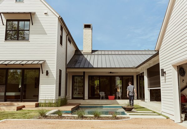 Homeowners Matthew and Lindsay Thomas, who build houses for a living, worked with architects Todd Hamilton and Scott Slagle to create their own residence—a vernacular form characterized by horizontal clapboard cladding and a standing-seam, paint-grip roof.
