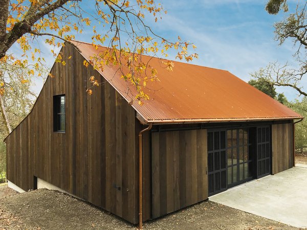 To keep to a barn vocabulary, Faulkner Architects replaced small windows with a large, steel-framed glass opening that can be seamlessly enclosed behind sliding wood doors. 