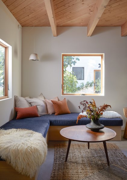 The ceramic pendant above this cozy corner bench is by local studio Notary Ceramics; the wood table is by Vince Skelly.