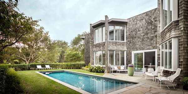 The backyard, which Lauren Rottet completely remodeled with new landscaping and a heated saltwater pool, is the ideal spot to relax on a balmy New England summer day. 
