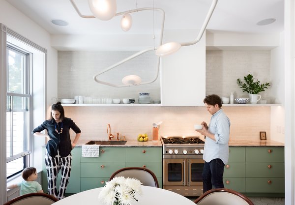 The couple’s bold mix-and-match sensibility applies most unconventionally to the material palette; nearly every surface is different from the next. The cook station pairs a copper Watermark faucet with an Italian marble countertop, a copper-toned stainless-steel range from Blue Star, and a backsplash of masonry Foundation Brick tile by Ann Sacks.