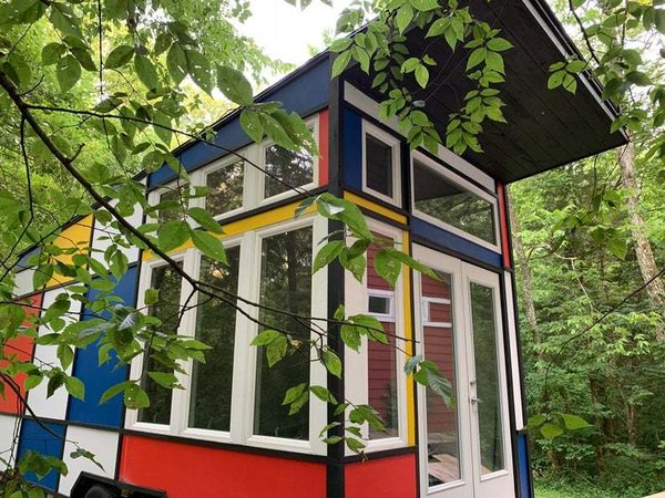 Boasting a Mondrian-inspired grid of bright colors, this 170-square-foot mobile tiny house is road-ready and guaranteed to stand out. 