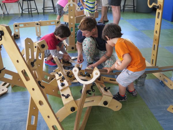 Cas Holman designs "tools for imagination." Rigamajig is a large-scale building kit that includes wooden planks, wheels, pulleys, ropes, and hardware that allows for open-ended exploration. The weight and size of the materials call for kids to collaborate, helping each other hold parts up as the pieces come together. 