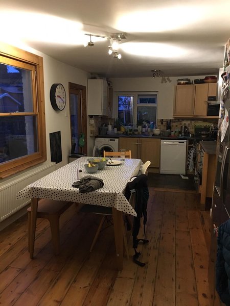 Before the renovation, the kitchen and dining space was narrow, dark and crowded. This original space was split over two levels, one a rickety timber floor and the other a badly-tiled concrete slab. 
