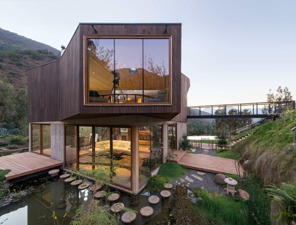 Featuring over 3,000 square feet of living space, Casa El Maqui is comprised of two box-like bases topped with an overhanging timber-clad structure.