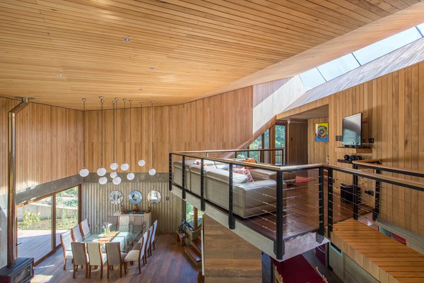 A long, slender skylight illuminates the top-floor lounge area. "The home’s location on the eastern slope of the creek ensures prolonged sunlight throughout the year, while also being optimally exposed to the prevailing rising air currents in the valley," states the firm.