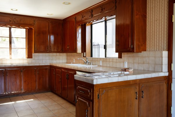 The dark-stained wood cabinetry made the kitchen feel closed in. 