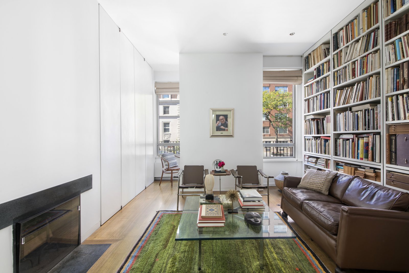Set on the parlor level of the home is a large and airy library, which can easily be converted into a fifth bedroom. Floor-to-ceiling bookshelves (designed by Pei) stretch across one wall, while bespoke doors on the opposite side hide even more storage.