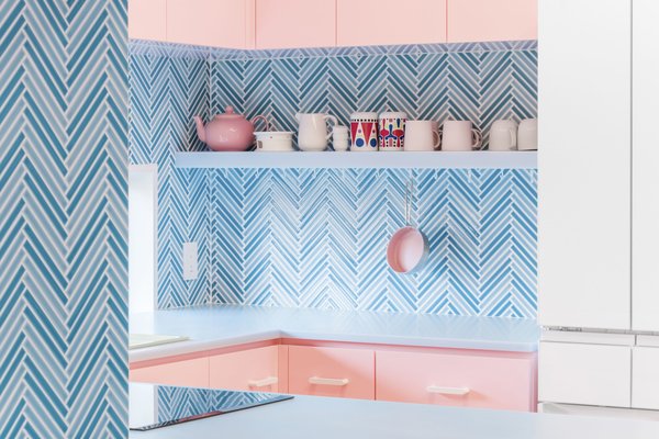 The design's color blocks are contrasted by the herringbone pattern of the backsplash, which still works with the pastel palette. 