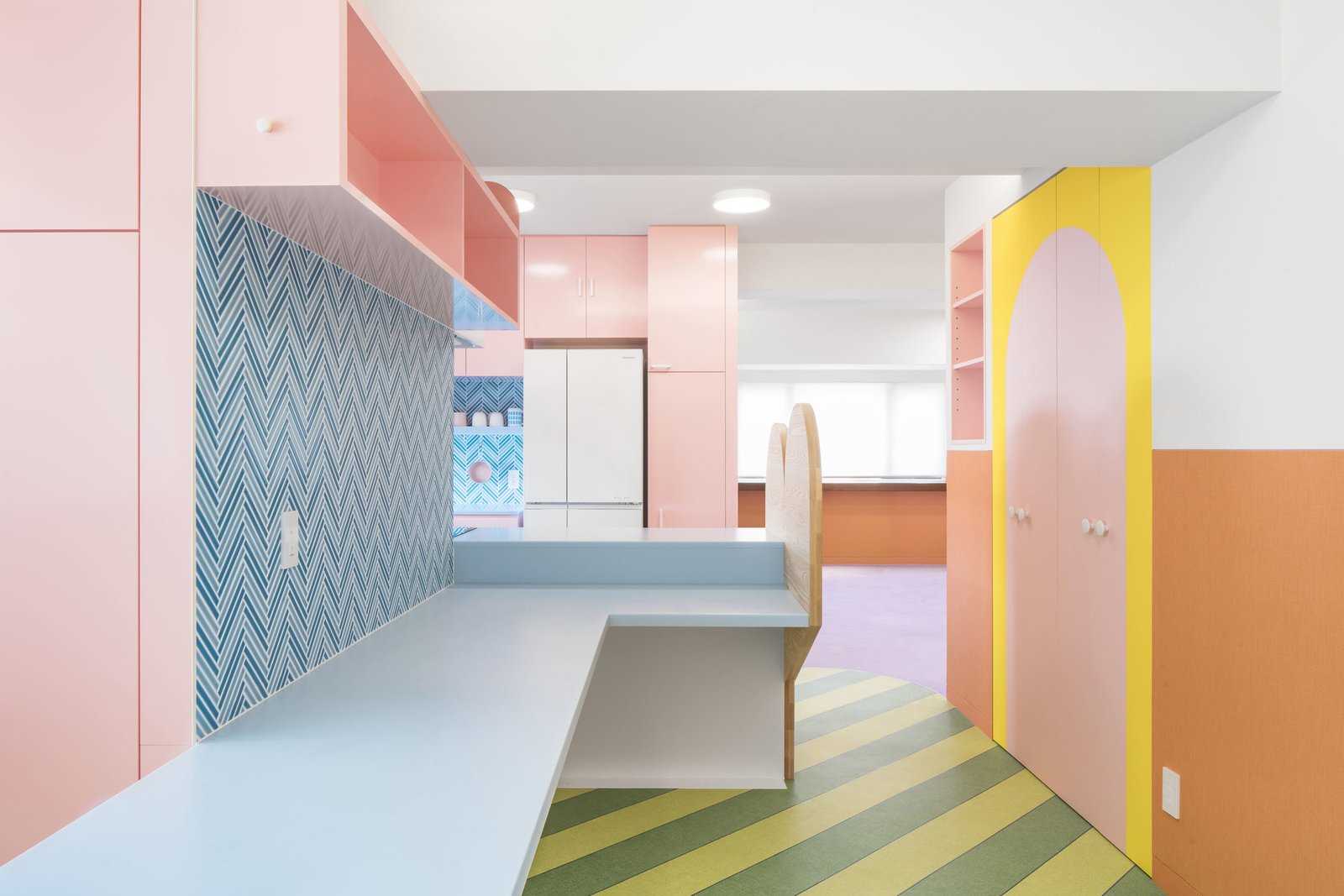 "We went through numerous palettes and found that pastels, punctuated by moments of bright saturation and natural materials, imbued the spaces with joy," he says. 