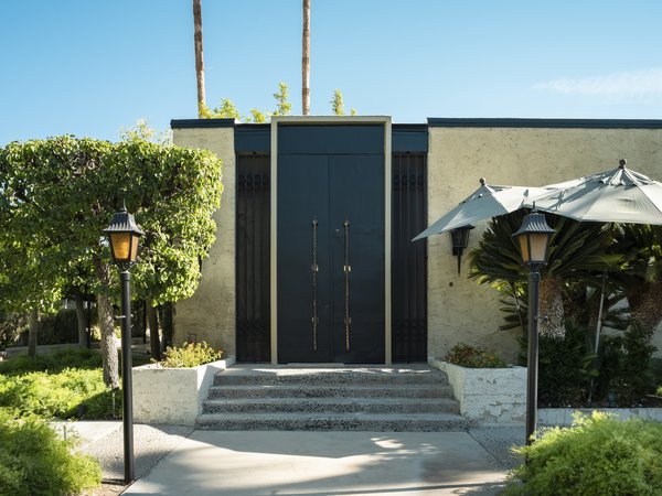 The Hollywood Regency–style home sits almost exactly as Elrod left it. The oversized doors feature antique Moroccan brass door pulls made from a four-poster bed.