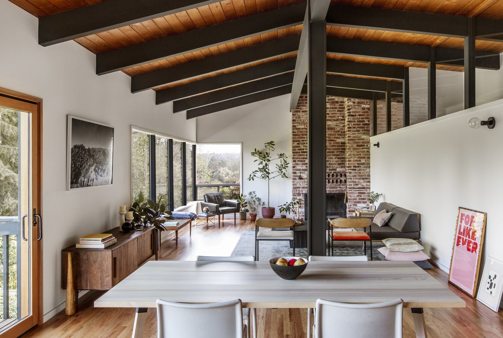 The original fireplace was kept, as was the interior clerestory windows that divide the main living area from the hall and master suite. The floors were replaced with red oak to align with preserved red oak flooring in the bedroom.