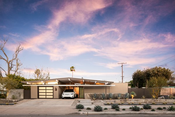 Built in 1962, the four-bedroom, two-bath home has already been spruced up with modern features that respect the home’s original midcentury modern character. Highlights include updated bathrooms with Carrara marble and walnut cabinetry, a private backyard, and a renovated kitchen with a pretty impressive "edible garden" off the side. 