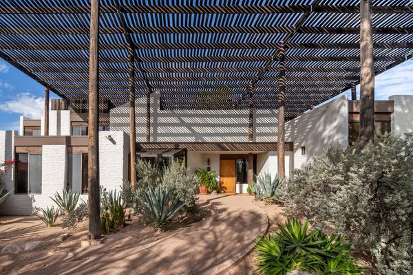 The home’s namesake is a 26-foot-tall shade structure called a ramada. The name derives from the Spanish word for ‘branches,’ and it’s a regional construction technique mastered by the Tohono O'odha tribe. A total of 20 Douglas fir telephone poles support the 2 x 4 lattice canopy, which provides shade and casts dramatic shadows across the white, mortar-washed slump blocks.