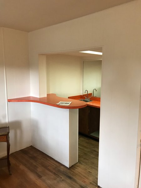 Before: There was an existing kitchenette in the basement that the couple removed, so they could relocate the kitchen against the concrete wall and expand its size. 