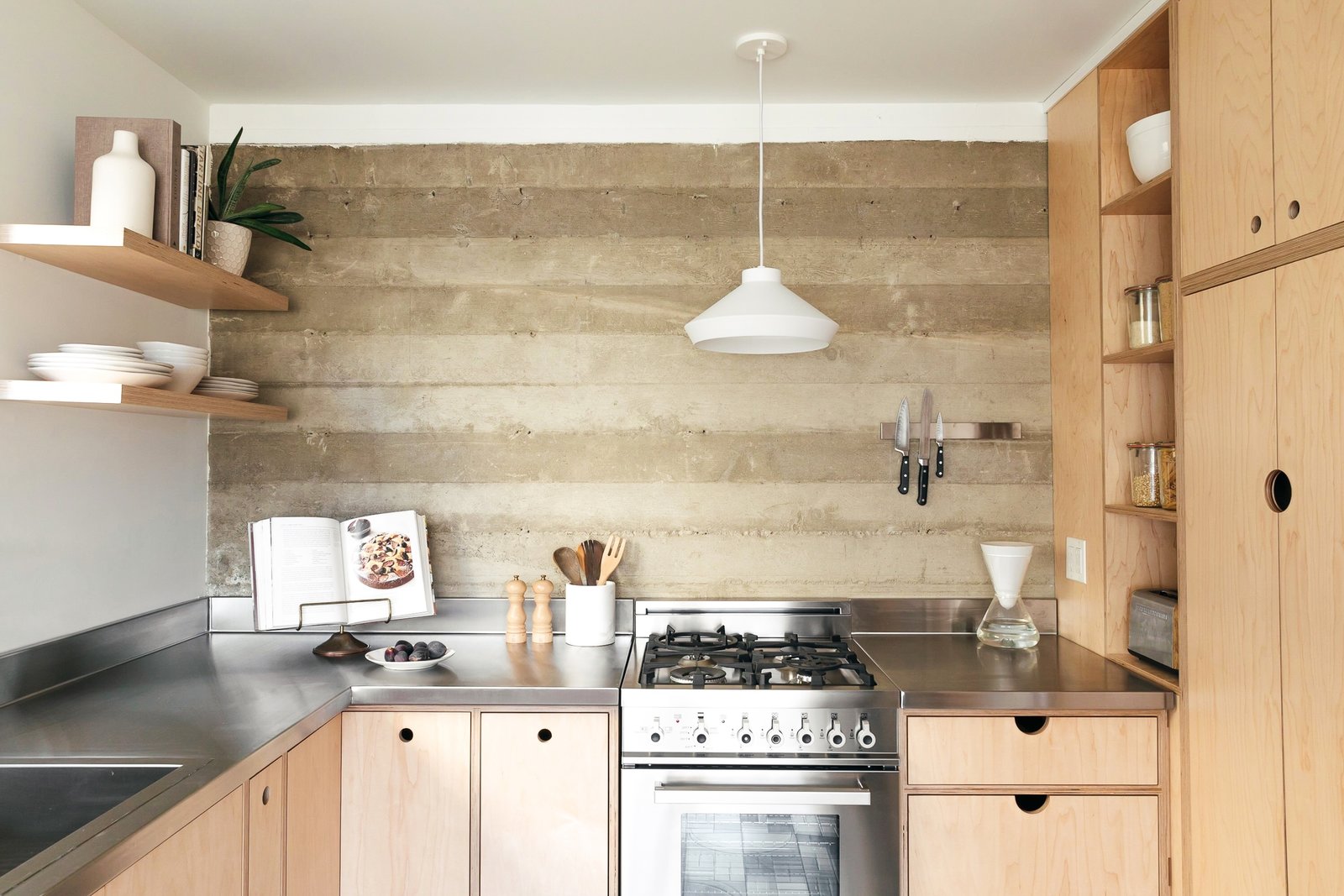 The couple opted for light-hued cabinetry with exposed edges and no hardware, custom-built from marine-grade ApplePly. Having the cabinets custom-made ensured that they could take advantage of every square inch in the small space.