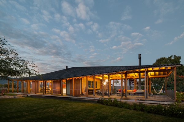 The upper portion of CMV house is notable for its transparency—glass walls enable you to see right through the house. The roof’s shallow angle and wide eaves make it feel comforting and homey.