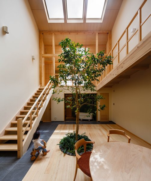 Infused with traditional materials and aesthetics, this open-plan home in Japan strengthens the bond a young family has to nature and to each other.
