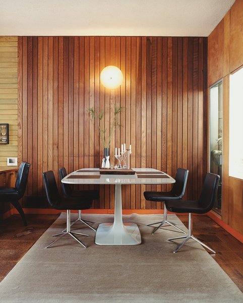 In 2005, Gretchen Rice and Kevin Farnham acquired a 1908 home in San Francisco that had been remodeled in the 1940s by well-known local architect Henry Hill. Their series of small interventions have kept the design intent of the 1940s renovation—including an enclosed atrium, wood wall paneling, and unusual built-ins—while updating the home for contemporary living. In the dining area, Metropolitan side chairs by Jeffrey Bernett for B&B Italia surround a Surf Table designed by Carlo Colombo for Zanotta.