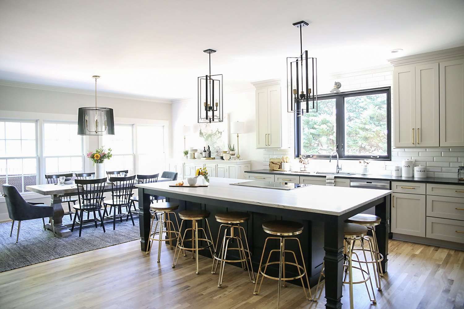 The old mahogany cabinets were swapped for lighter, cream-colored ones, which are contrasted by a large central island with black cabinetry.