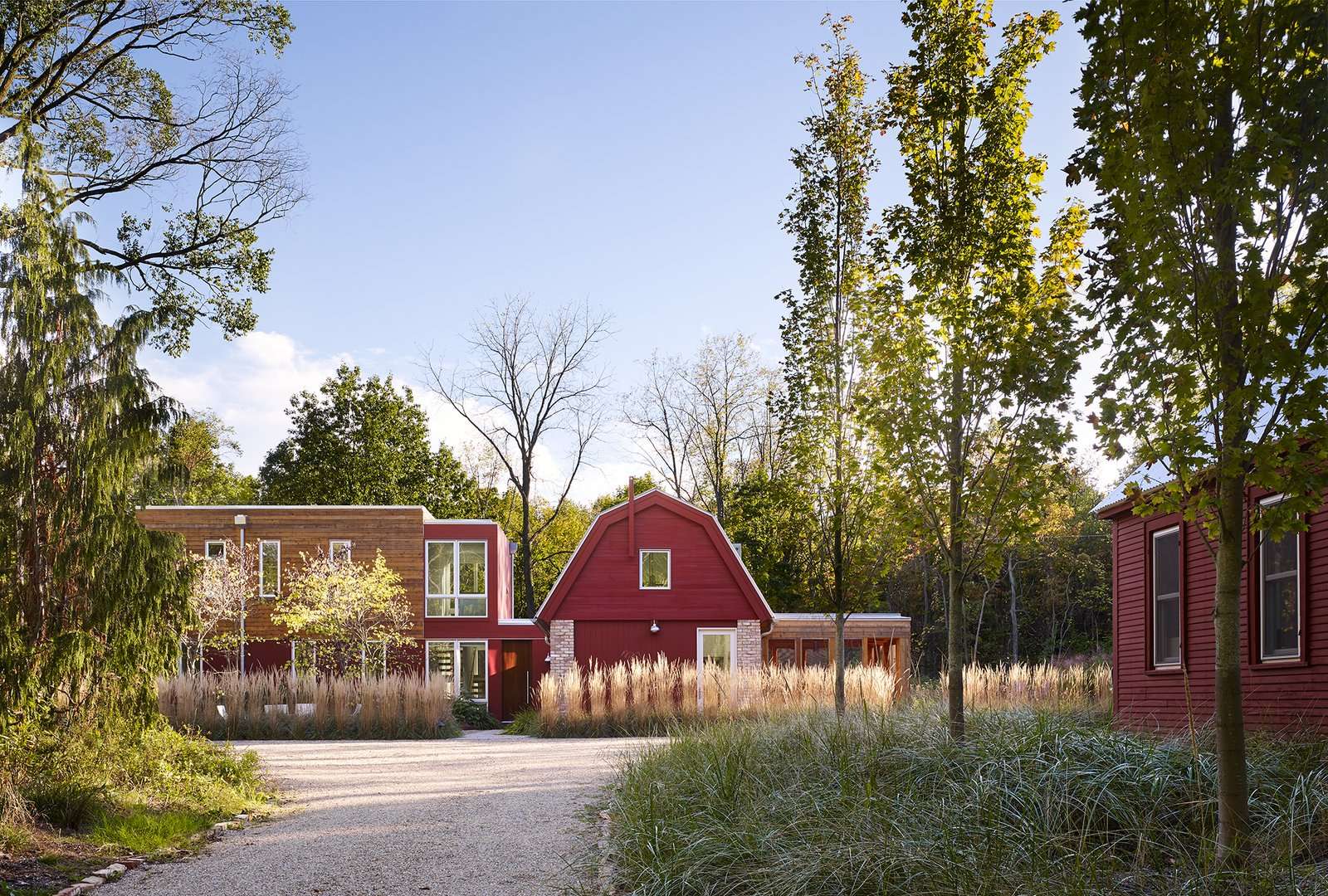 Vibrant red siding references the original buildings on the site.