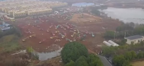 Bulldozers began leveling a site Thursday in Wuhan. 