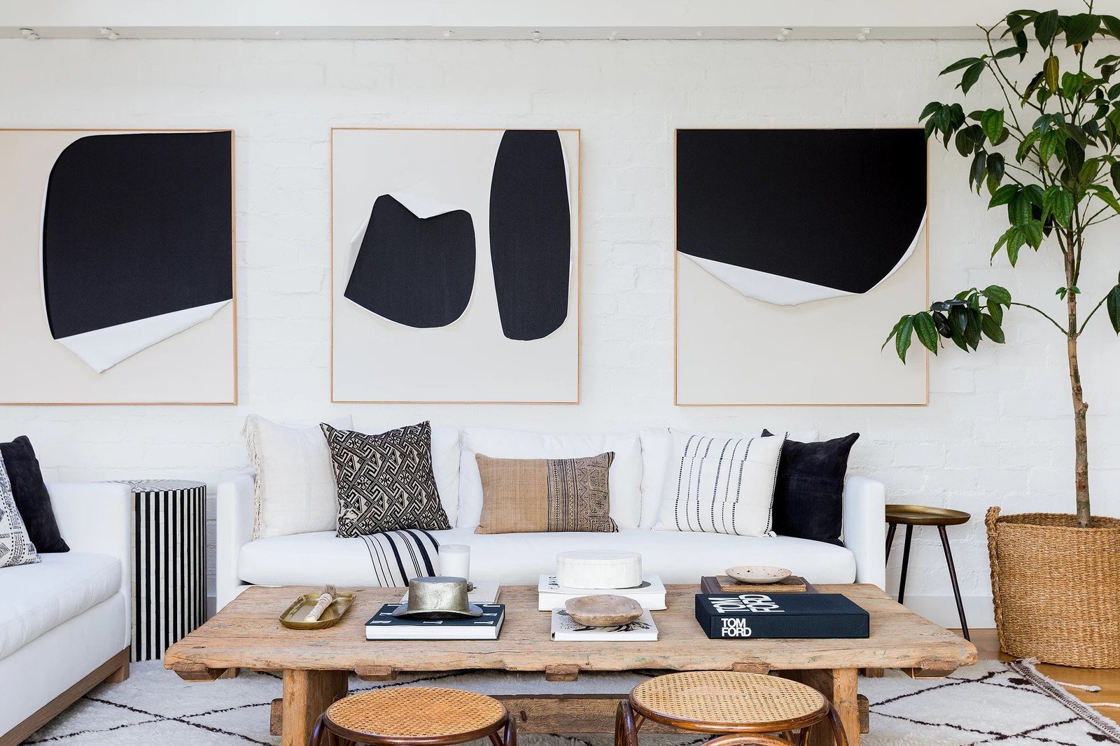 An accent pillow isn't the only place where neutral palettes can get some color. In this Hollywood Hills living room, Pickens creates a cohesive palette by using the same shades on the walls, rug, and side tables. 