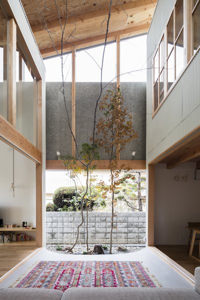 The home essentially comprises two structures that are unified by a double-height, courtyard-like space with clerestory windows allowing for ample natural light. 