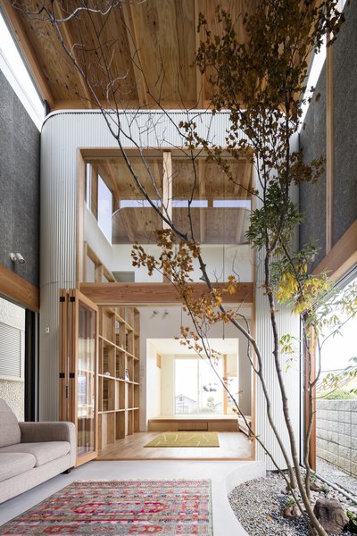 The centerpiece of this indoor/outdoor space is a "dry garden," providing some green space in place of an exterior yard. Sliding doors partition the space from the outside. 