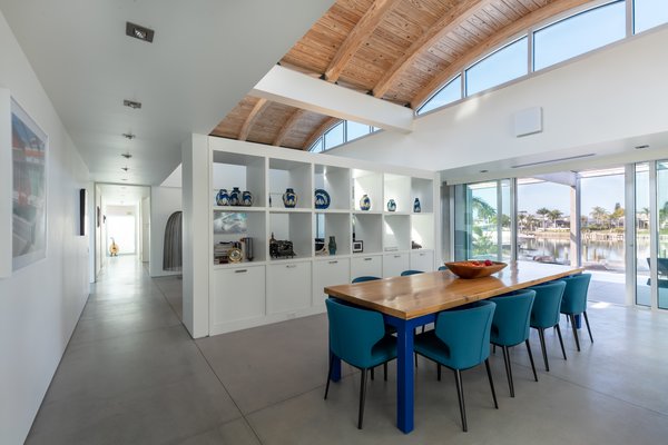 The dining room is separated from the living area by a built-in cabinet, both rooms are located under the home's airy vaulted ceiling. 