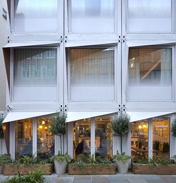 The end face of the containers were cut out and replaced with a fixed double-glazed window that spans the height of the unit. The glass is fritted on the lower part for privacy.