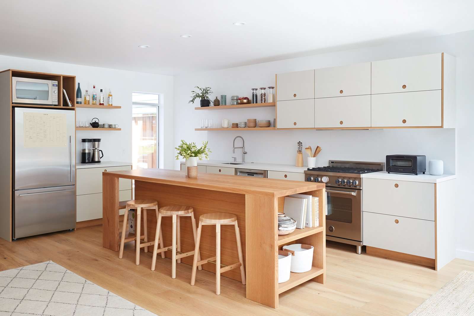 This lovely kitchen features laminate cabinets by Danish brand Reform.