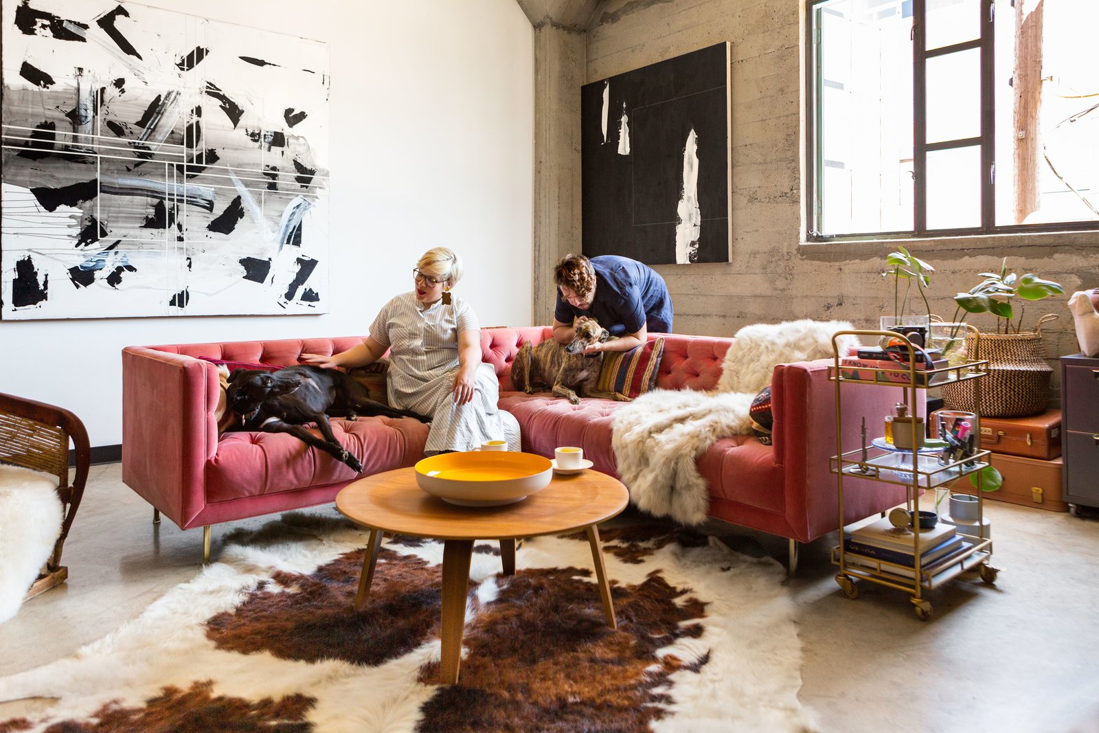 Morrison and her two greyhounds pose with her brother and roommate, Michael Anthony Morrison—an artist who is also responsible for much of her art collection.