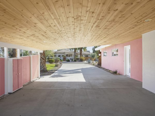 Located in the heart of Palm Desert, California, the 1956 property at 72862 Parkview Drive features a large, covered carport. The wood-clad ceiling is repeated inside the home.