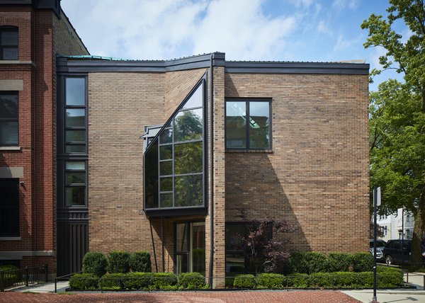 The mostly blank brick-clad exterior belies the complex geometries that inform the multilevel plan inside. The windows are arranged to frame specific views—including the steeple of the nearby St. Michael’s Church—while retaining privacy from the street.